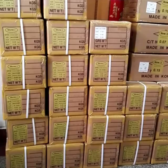 Cartons of ShyneX Korean PBT lash fiber, made in Korea, stacked in the LashPlus warehouse